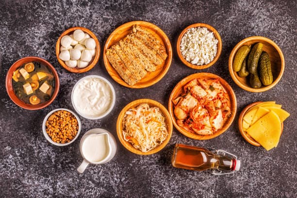 Selection of probiotic-rich foods including yogurt, kefir, and kimchi.